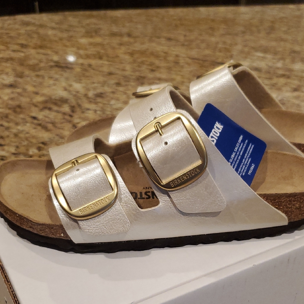 2026 Birkenstock Metallic Pearl Cream Sandals with Gold Buckles.